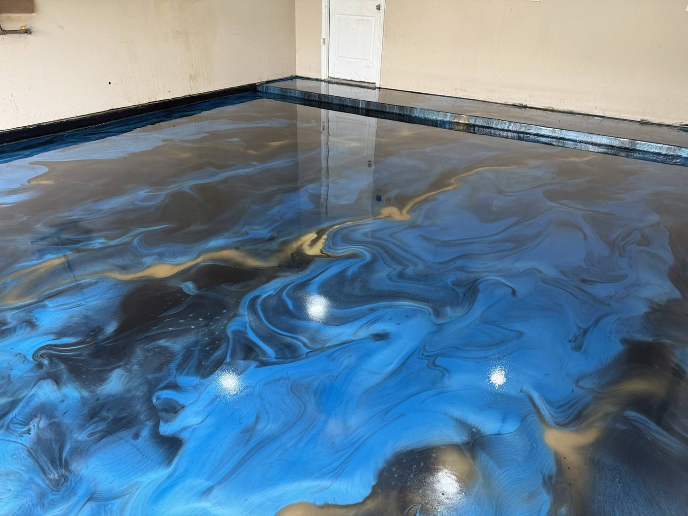 Blue and gold metallic epoxy floor gleaming like liquid metal