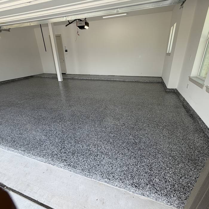 Bright gray flake epoxy floor across a clean garage