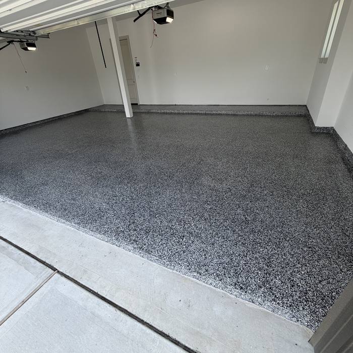 Gray flake epoxy floor meeting the garage wall