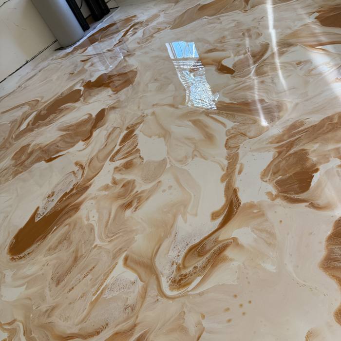 Copper swirls across a white metallic epoxy surface