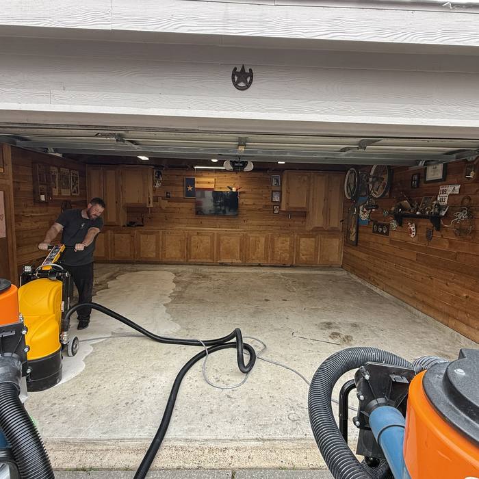 Skilled Bros crew diamond grinding a garage slab before coating