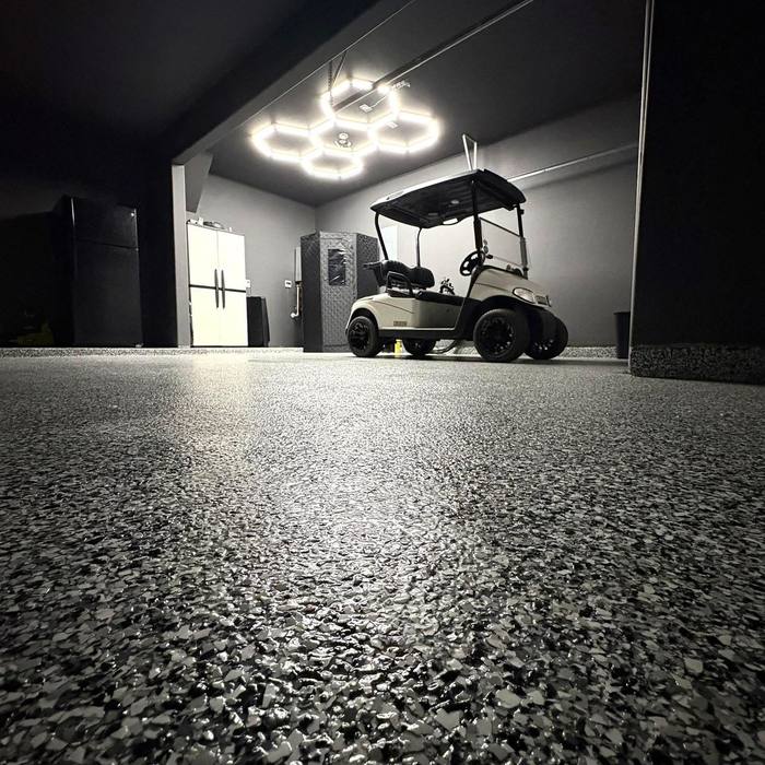Flake floor in a golf cart showroom lit at night