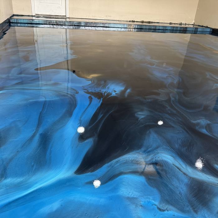 Ocean blue and gold metallic epoxy floor marbled like deep water