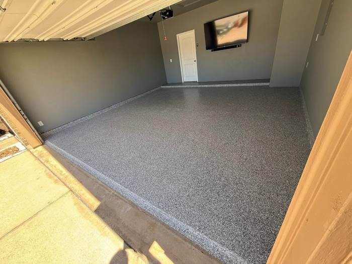 Gray full flake epoxy floor across a two car garage