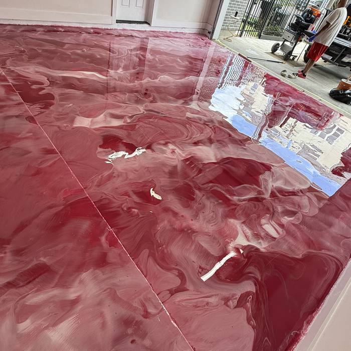 Burgundy metallic epoxy floor in a bright room