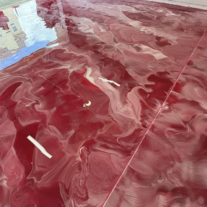 Burgundy metallic epoxy floor detail with white marbling