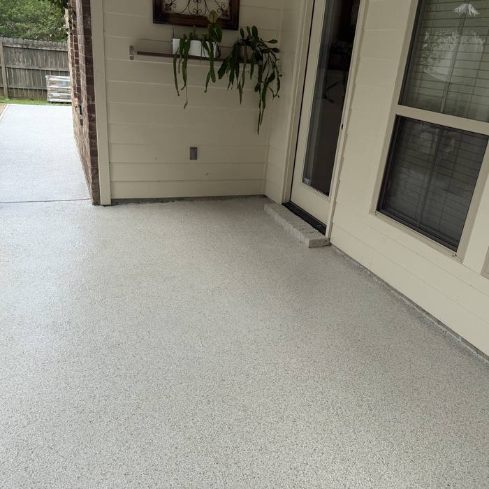 Coated walkway and patio along a brick home