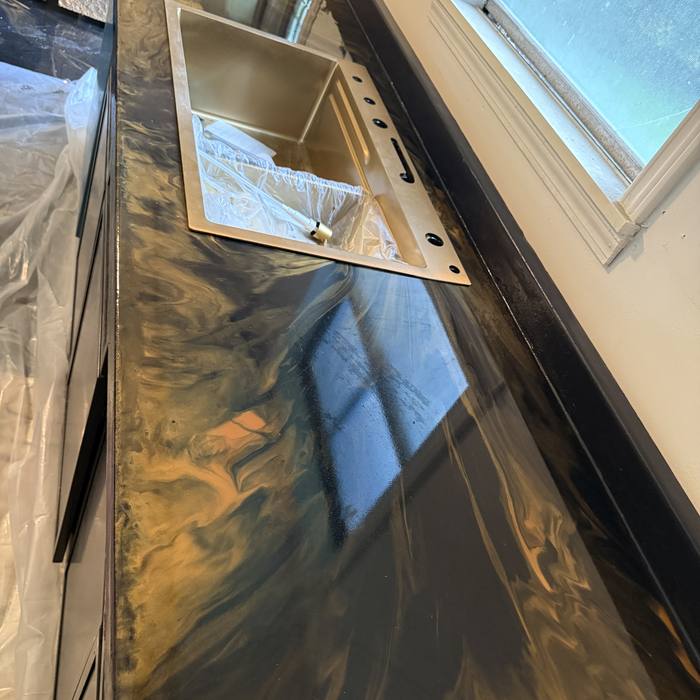 Blue, black and copper metallic countertop by a window