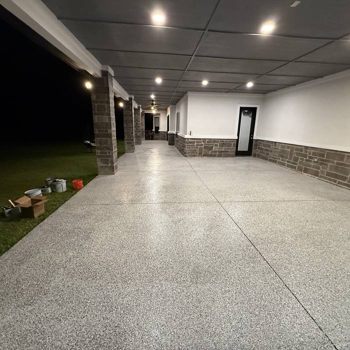 Gray flake epoxy floor down a long commercial corridor