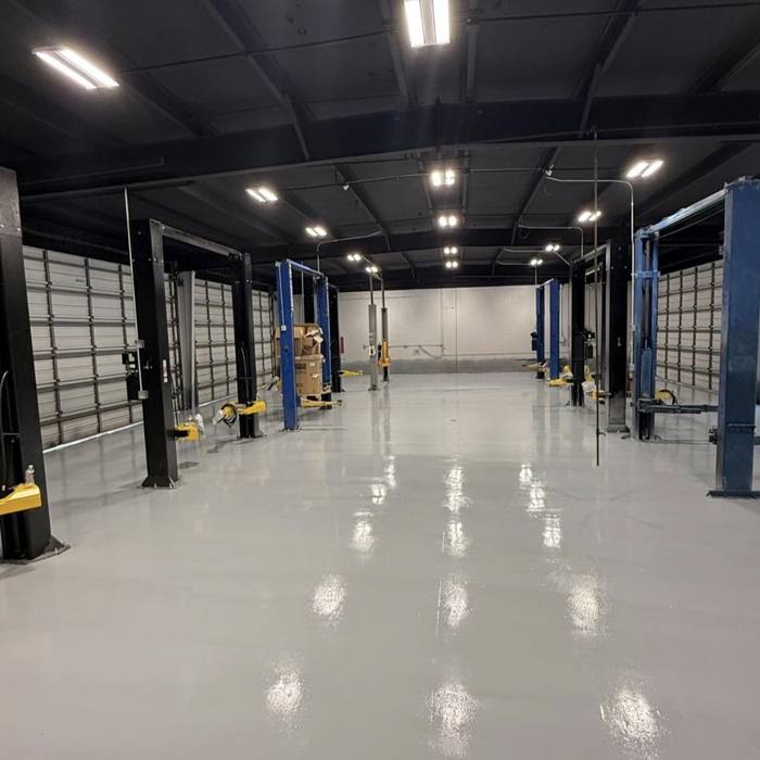 Finished glossy warehouse floor marked complete