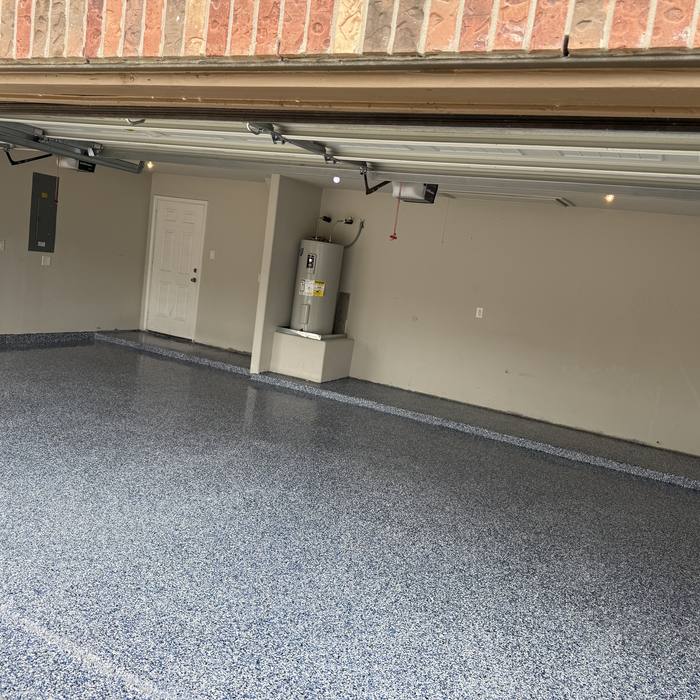 Gray flake epoxy garage floor viewed from the driveway