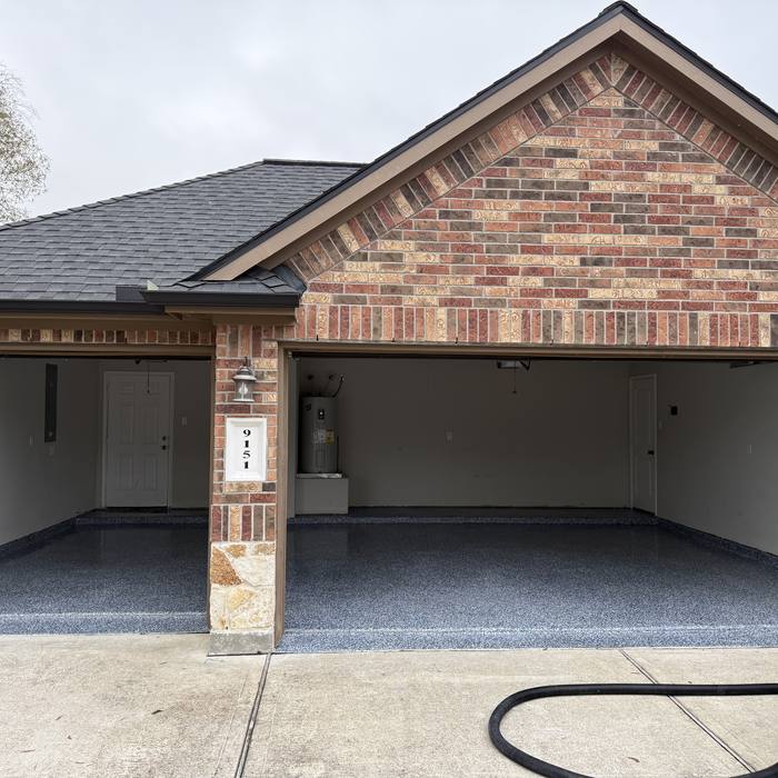New flake epoxy floor under the carport of a brick home
